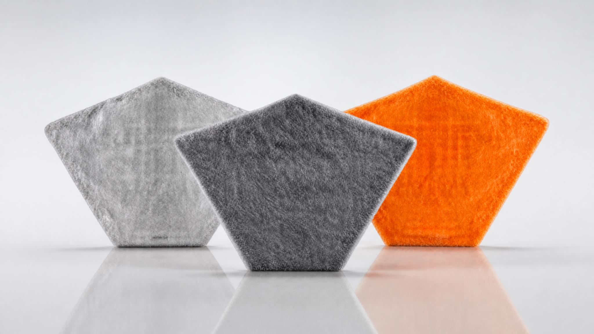 Pile cloth filter media by R+F FilterElements – three pentagonal filter segments in white, grey and orange
