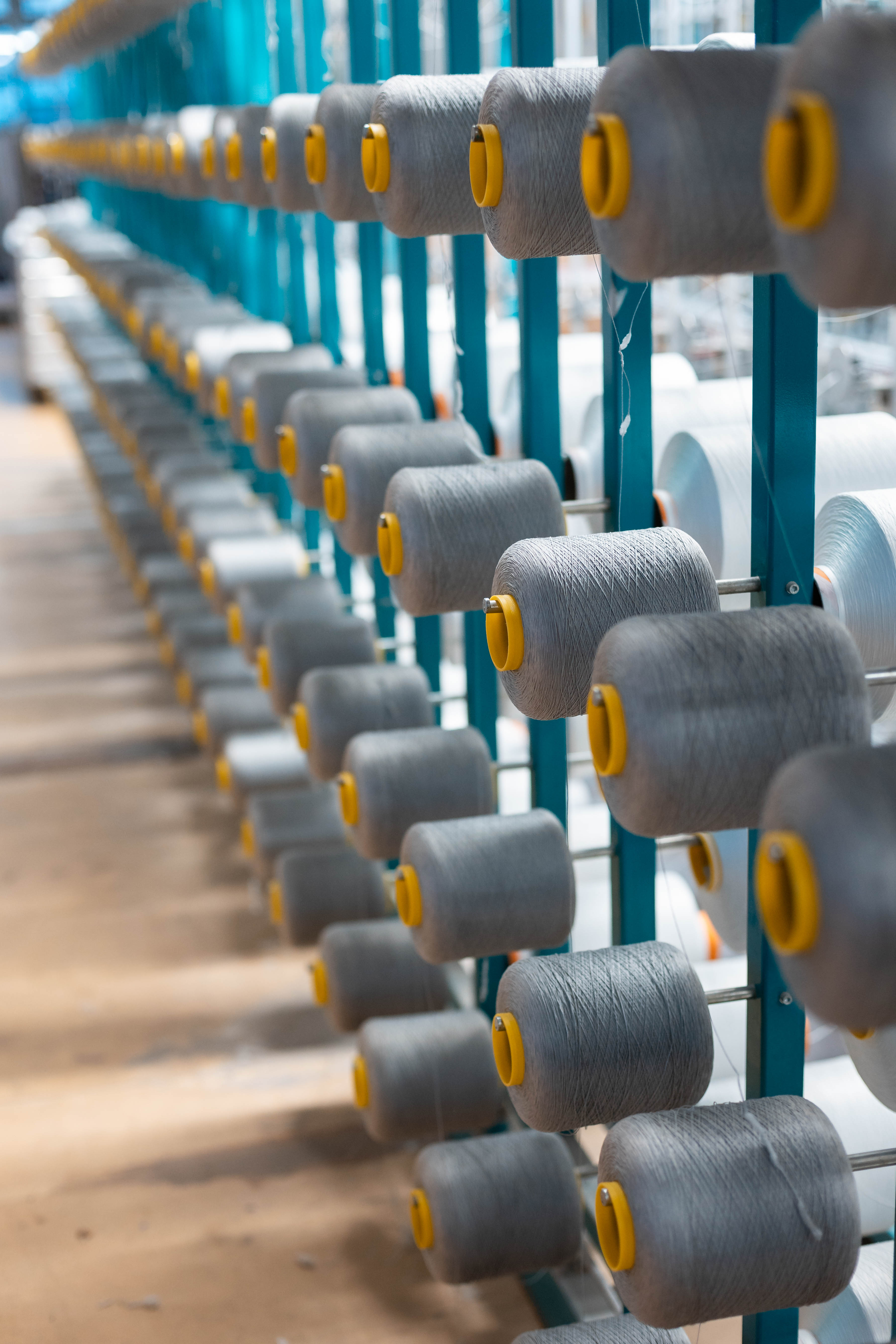 Fiber spools for pile filter cloth textile manufacturing at R+F FilterElements GmbH