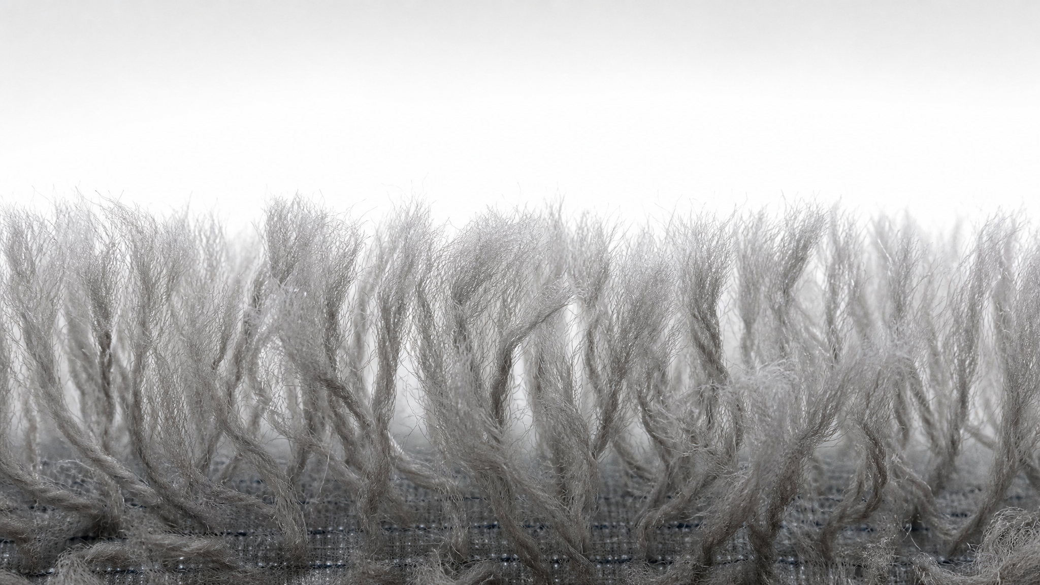 Macro close-up of R+F FilterElements pile cloth filter media showing 3D fiber structure for wastewater filtration
